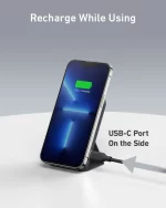 Anker MagGo power bank attached to iPhone charging via USB-C port on stand